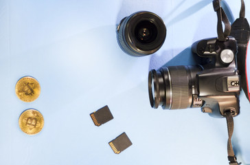 Camera, lens, memory drive on a blue background, close-up
