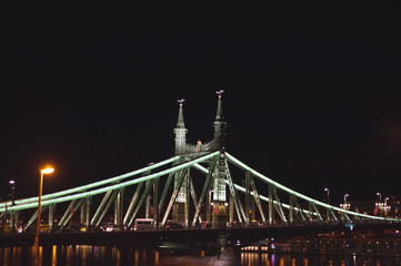 Night view of a bridge that spans the River Danube