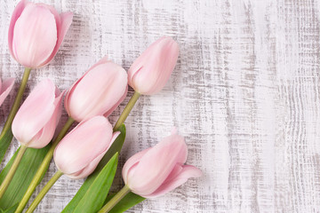 beautiful tulips on wooden background