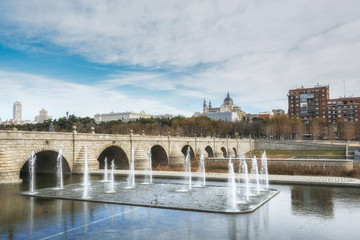 Segovia bridge in winter on the Manzanares river with the Cathedral Santa Maria la Real on the background. Madrid, Spain.