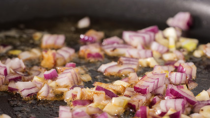 Frying red onion and garlic in pan