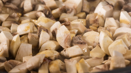 Frying brown mushrooms in pan
