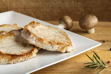Three pieces of pork sirloin on white plate
