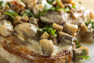 Pork sirloin with white sauce made from sour cream and mushrooms