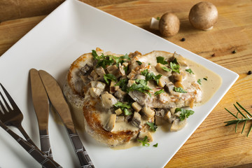 Pork sirloin with white sauce made from sour cream and mushrooms