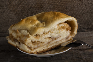 Homemade strudel pie on plate with teaspoon