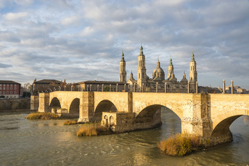Cathedral-Basilica of Our Lady of the Pillar and Stone bridge in Zaragoza, Spain.