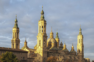 Fototapeta na wymiar View of the Cathedral-Basilica of Our Lady of the Pillar in Zaragoza during the sunrise, Spain.