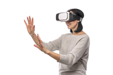 Young woman in a virtual reality helmet on a white.