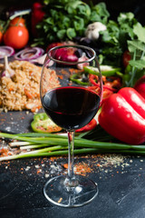 A glass of semisweet or dry red wine on vegetable background. National Georgian alcohol drinks. Wine pairing concept