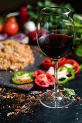 A glass of semisweet or dry red wine on vegetable background. National Georgian alcohol drinks. Wine pairing concept