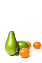 Avocados and tangerines isolated on white