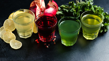 assortment of Georgian nonalcoholic drinks. Pomegrante juice, lemonade, tarkhun and mint refreshing beverages. Healthy lifestyle