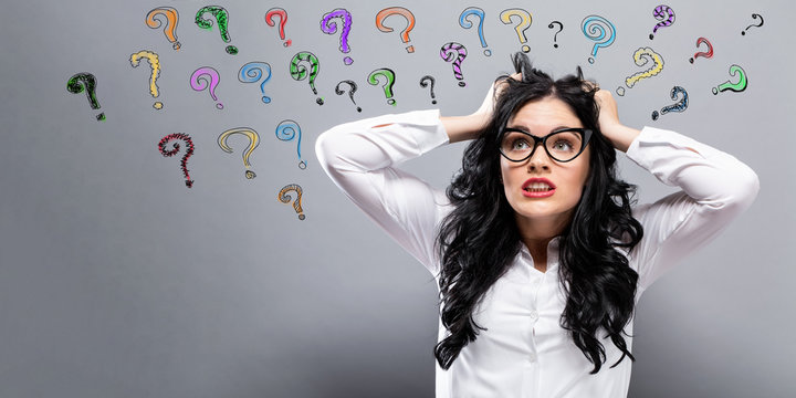 Question Marks with young woman feeling stressed