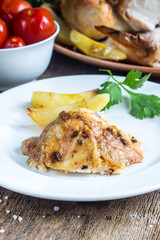 Roasted chicken with potato on a pan
