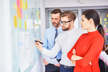 Obraz premium Three colleagues coworking during business meeting in office