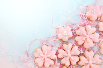 Homemade pink cherry blossom cookies, Easter holiday theme sweeties decoration background, toned