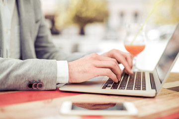 Young man using his laptop,close up.