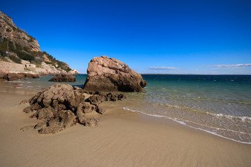 Beach with turquoise sea water with amazing rocks. Setubal in Portugal