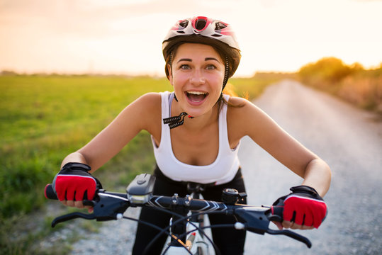 An excited girl rides a bicycle