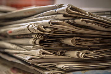 Stacked old news paper on the table waiting for recycles