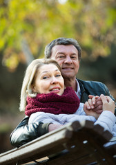 Portrait of senior couple in park .