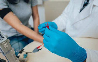 Patient nerves testing using electromyography. EMG