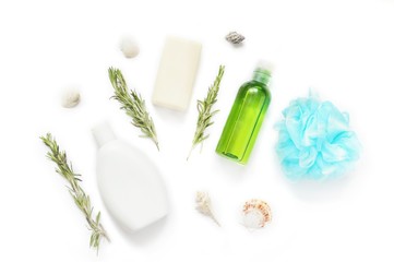 Flat lay natural organic bath products/ Shampoo bottle, soap bar, essential oil, rosemary herbs and blue bath sponge