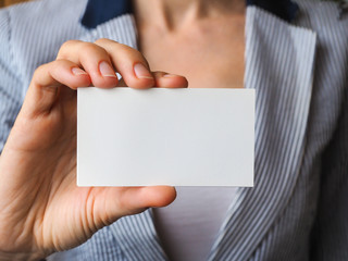 Business card with copy space in the hand closeup.
