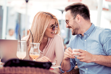 Young couple talking at coffee shop on a date.