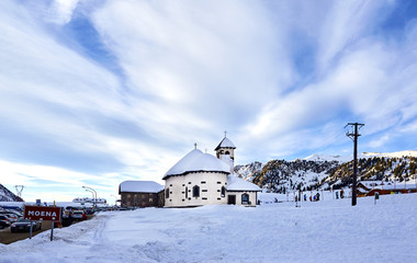 Passo San Pellegrino. Little church situated in the Dolomites, at Passo San Pellegrino. Ski resort, Ski slope. Mountains alps. Moena, Italy, Alps. Snowy winter Alps mountains at sunny day.