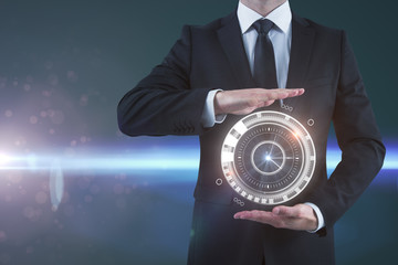 Businessman holding digital clock