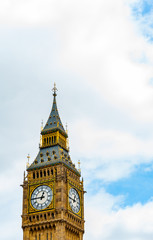 Fototapeta na wymiar Big Ben clock tower, London UK set against clouds in sky with copy space top and side
