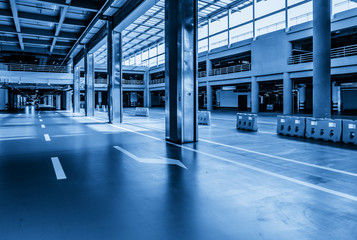 interior of parking garage with car and vacant parking lot in parking building