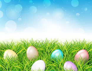 Colorful Easter eggs in grass. Spring landscape with blue sky. Greetig card template. Spring easter design