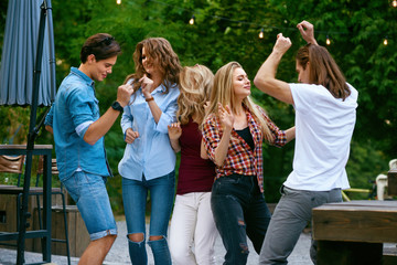 Happy Friends Dancing, Having Fun And Enjoying Party Outdoors.