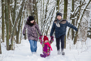 Fototapeta na wymiar Happy young family in winter outdoors