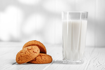 Milk in a glass and oatmeal cookies. The concept is healthy food, breakfast, vegetarianism.