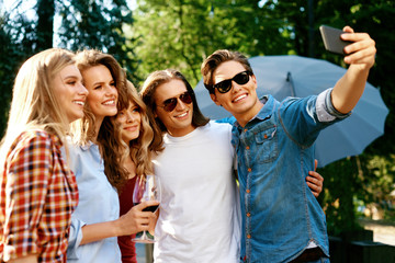 Happy Friends Taking Photos And Having Fun On Weekend