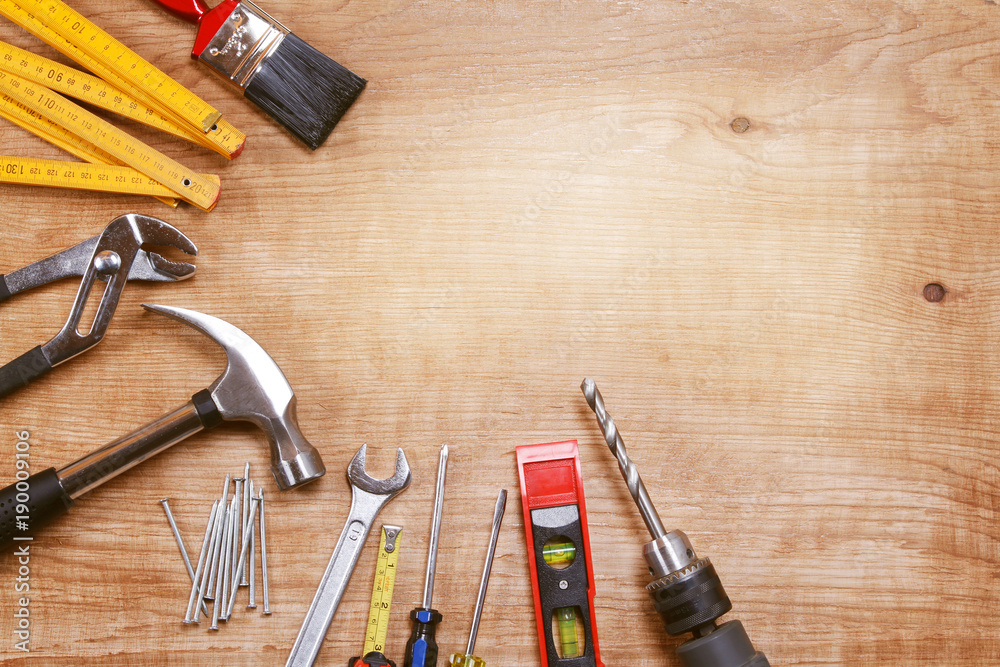 Poster assorted carpentry hand tools on wooden background