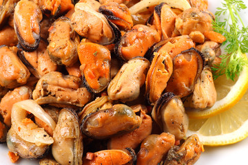 marinated mussels in white plate isolated on white background