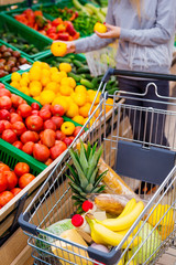 Consumerism concept. Woman doing grocery shopping at supermarket