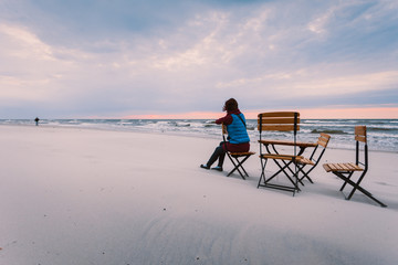 Woman sitting on beach relaxing