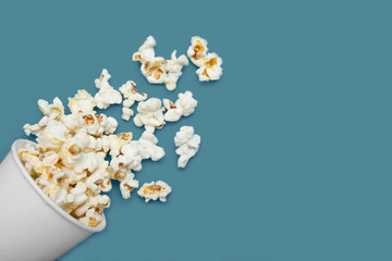 Popcorn, scattered from a white cup. Copy space. © Andrii Zastrozhnov