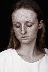 closeup studio portrait of freckled woman without makeup - 190012964