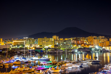 Marina next to volcano Vesuvius at night 