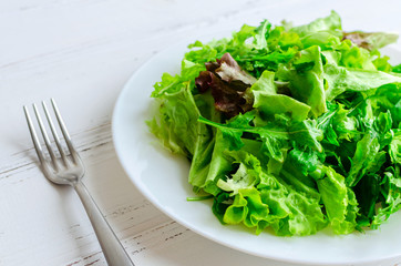 Lettuce salad mix on a wooden table