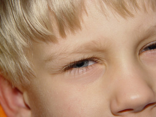 Face of a boy of several years, close-up on a face fragment