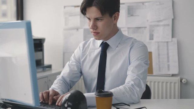 Tired thoughtful man working deligently with pc in office. 4K