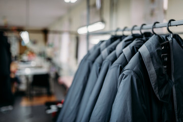 Row of jackets on hangers, clothing store, fabric
